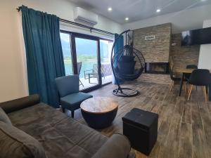 a living room with a couch and a table at MONTEKARLO NA DRINI in Mali Zvornik