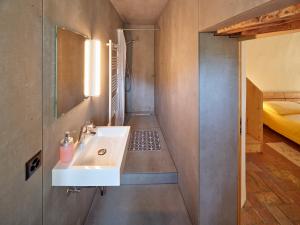 a bathroom with a sink and a bed at Bed and Breakfast Chiarina in Mendrisio
