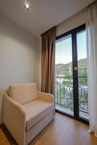 a living room with a couch and a balcony at Hotel Central in Vlorë