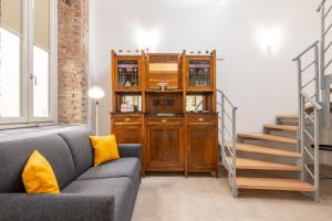 a living room with a couch and a wooden cabinet at A Casa di Gianna in Cagliari