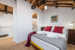 a bedroom with a bed with red pillows on it at A Casa di Gianna in Cagliari