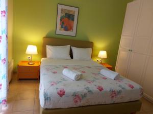 a bedroom with a bed with two pillows on it at PLEIADES lUXURY APARTMENTS in Porto Heli