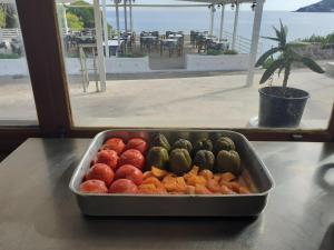 a tray of fruits and vegetables on a table at Hotel 3 Adelfia in Agia Marina Aegina