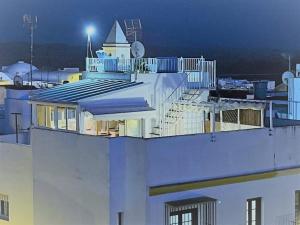 a building with a staircase on top of it at night at Duplex ático con las mejores vistas de Conil in Conil de la Frontera