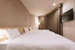En eller flere senge i et værelse på Park Central Sakura Hotel