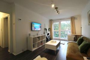 a living room with a couch and a table at The Eagles Nest in Norwood