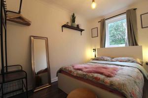 a bedroom with a bed and a large mirror at The Eagles Nest in Norwood