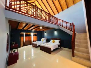 a bedroom with two beds and a staircase at Villa Moon Light Nuwara Eliya in Nuwara Eliya