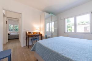 a bedroom with a bed and a desk and window at Villa Maya in Pula