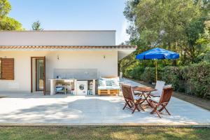 a patio with a table and chairs and an umbrella at Villa Maya in Pula