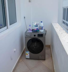 een wasmachine in een kamer naast een raam bij Kijani Suites in Malindi
