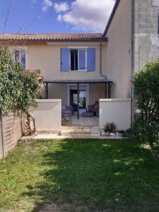 a house with blue doors and a yard at La Retraite Parfaite in Loubès-Bernac