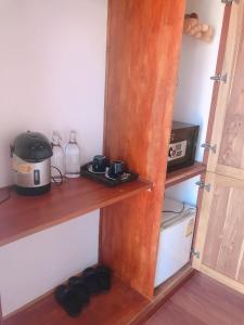 a kitchen with a cupboard with a microwave and aether at QUEEN'S HOUSE in Luang Prabang