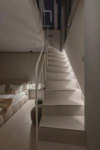a staircase in a room with a bed and a stair case at SPA apartamentai Palanga in Palanga