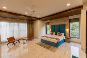 a bedroom with a king sized bed and large windows at SURAMYA-A Luxury Boutique Hotel in Udaipur +37 photos