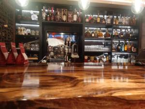 a bar with a wooden floor and shelves of alcohol at 北京悦明元星空白塔景观四合院民宿 in Beijing