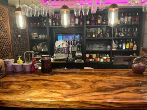 a bar with a wooden counter top in a room at 北京悦明元星空白塔景观四合院民宿 in Beijing