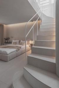a bedroom with a bed and a stairway with a bed at SPA apartamentai Palanga in Palanga