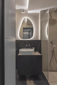 a bathroom with a sink and a mirror at SPA apartamentai Palanga in Palanga
