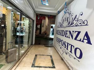 a shop with a sign on the side of a building at RESIDENZA ESPOSITO in Naples