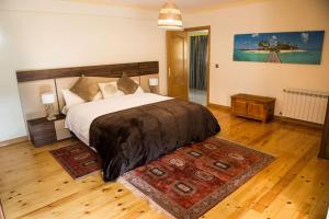 a bedroom with a large bed and a rug at Chalet de 6 habitaciones en la Sierra de Madrid El Olivo de Miraflores in Miraflores de la Sierra +22 photos