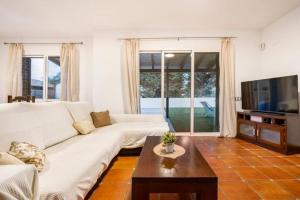 a living room with a white couch and a table at Holiday Home Valencia in Riba-Roja De Turia