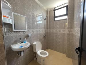 a bathroom with a toilet and a sink at La Brise Studio à Taghazout 2-3px in Taghazout