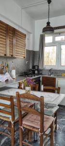 a kitchen with a table and chairs in a kitchen at Dimitra's in Amarynthos