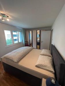 a bedroom with a large bed and a couch at Centered Apartment with view in Altdorf