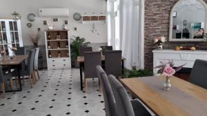 a dining room with a table and chairs at Victoria Family Hotel in Balchik