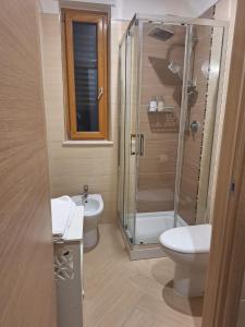 a bathroom with a shower and a toilet and a sink at DOMUS 0143 in San Giorgio Ionico +73 photos