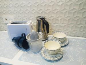 a counter with three tea cups and a toaster at MEGANO, apartamento a estrenar en la ruta vinos. junto a estanciones. in Oviedo