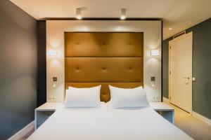 מיטה או מיטות בחדר ב-Hotel JL No76