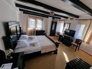 a bedroom with a large bed and a piano at Podu' cu Lanturi in Bacău