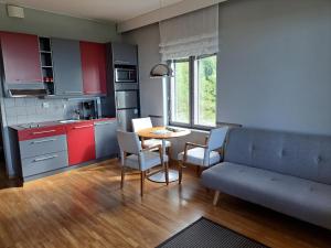 a kitchen with a couch and a table and chairs at Aparthotel Simpsiönkullas in Lapua