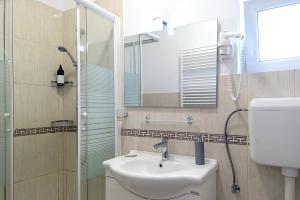 a bathroom with a sink and a shower at CONFORT HOUSE PLUS in Alba Iulia +19 photos