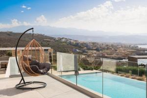 a hammock on the roof of a house with a pool at Tholaria Villa in Chania Town