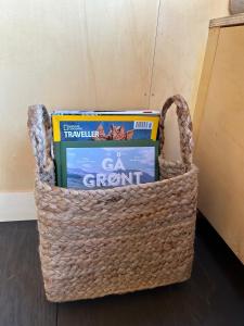 a basket filled with books and textbooks on the floor at Little house in Kongsvinger in Kongsvinger