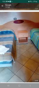 GalliateMambly b&b ristorante pizzeria的一间卧室，配有一张床和一张床头柜，床边有一张床