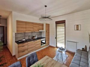 a kitchen with a couch and a table in a room at Apartman Central Square in Gospić
