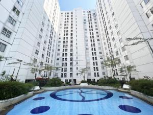 an empty swimming pool in front of tall buildings at Bassura Apartment by Aok Property in Jakarta