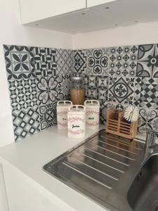 a kitchen counter with a sink and tiles on the wall at Ferienwohnung in Werder Havel Innenstadt in Werder +21 photos