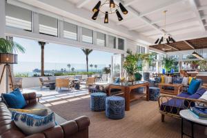 a living room with couches and tables at The Seabird Ocean Resort & Spa, Part of Destination Hotel by Hyatt in Oceanside