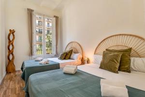 Habitación con 2 camas y ventana en Clandestino Suites, en Barcelona
