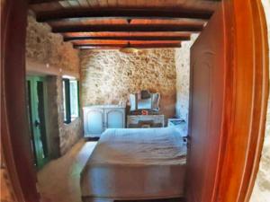 a bedroom with a bed and a dresser in a room at Villa Drogari in Éxo Apídhion