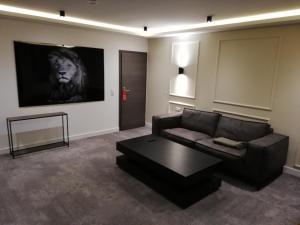 a living room with a couch and a coffee table at 3 Monkeys Hotel in Steinfurt