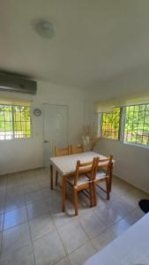 a dining room with a table and two chairs at Cozy Apartment in La Romana