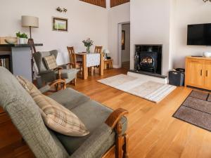 a living room with a couch and a fireplace at Bramble Lodge in Northwich