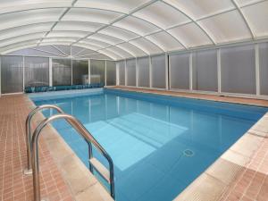 a large swimming pool with an overhead at Bramble Lodge in Northwich