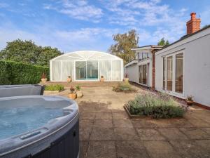 a hot tub in the backyard of a house at Bramble Lodge in Northwich